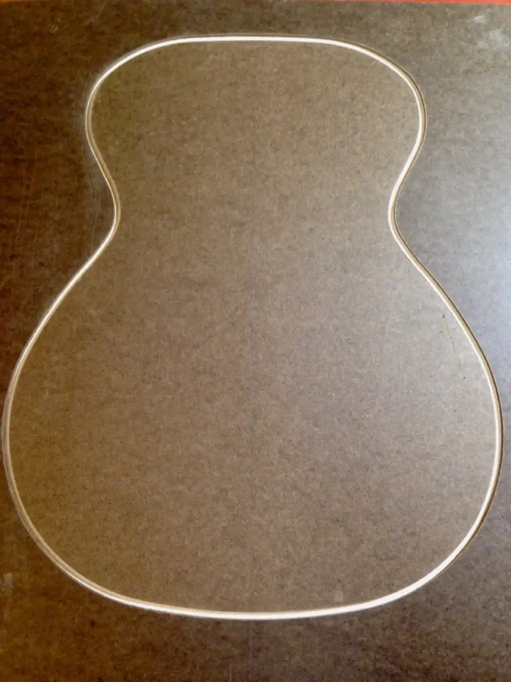 Hardboard cutout taped to plywood