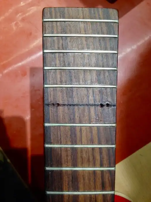 4 holes in fretboard (the 2 inside holes were successful)